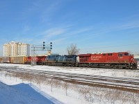<b>A trio of GE's</b> GE ES44AC's CP 8765 & CP 8916 sandwich GE AC4400CW CEFX 1050 on CP 118 through Dorval. In the foreground is the parallel CN Kingston Sub.