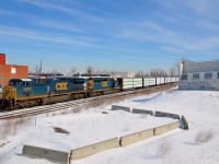 <b>Popular and not-so-popular models on CN 327.</b> CN 327 heads through Dorval with AC6000CW CSXT 5013 and SD40-2 CSXT 8037 for power on a sunny morning. Only 207 AC6000CW's were ever built and most if not all have been repowered. On the other hand, close to 4,000 SD40-2's were built and they continue to soldier on, on short lines and even sometimes on class ones, as shown here.
