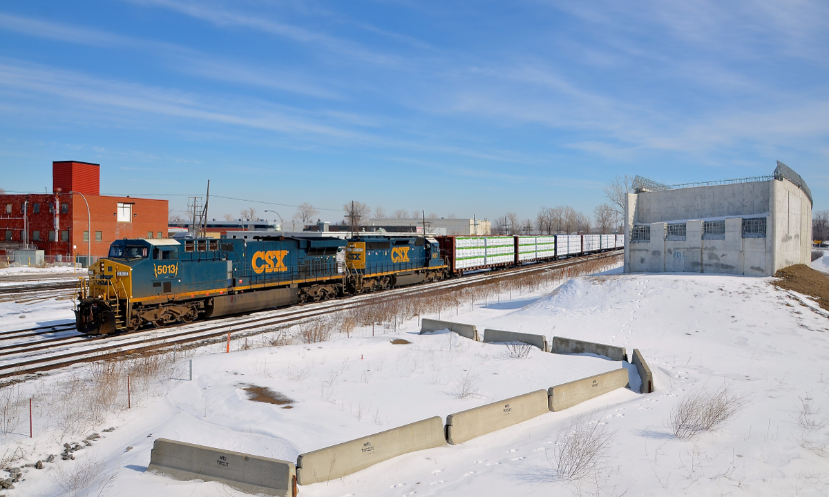 Popular and not-so-popular models on CN 327. CN 327 heads through Dorval with AC6000CW CSXT 5013 and SD40-2 CSXT 8037 for power on a sunny morning. Only 207 AC6000CW's were ever built and most if not all have been repowered. On the other hand, close to 4,000 SD40-2's were built and they continue to soldier on, on short lines and even sometimes on class ones, as shown here.