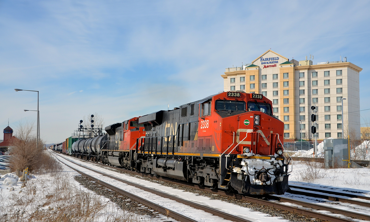 A smiling locomotive! CN 2338 has had a smile etched in the road grime on its front end as it leads CN 368 through Dorval. Trailing is CN 8913, with CN 2333 operating mid-train.