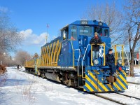 <b>A crowded genset front end.</b> POM 1001 is stopped to participate in the Old Port Symphony, a twice annual event which involves boats, trains and church bells making a lot of noise in the Port of Montreal. Some of the participants in the event are on the front of the locomotive with more inside the cab. Behind the genset is slug POM 2007.