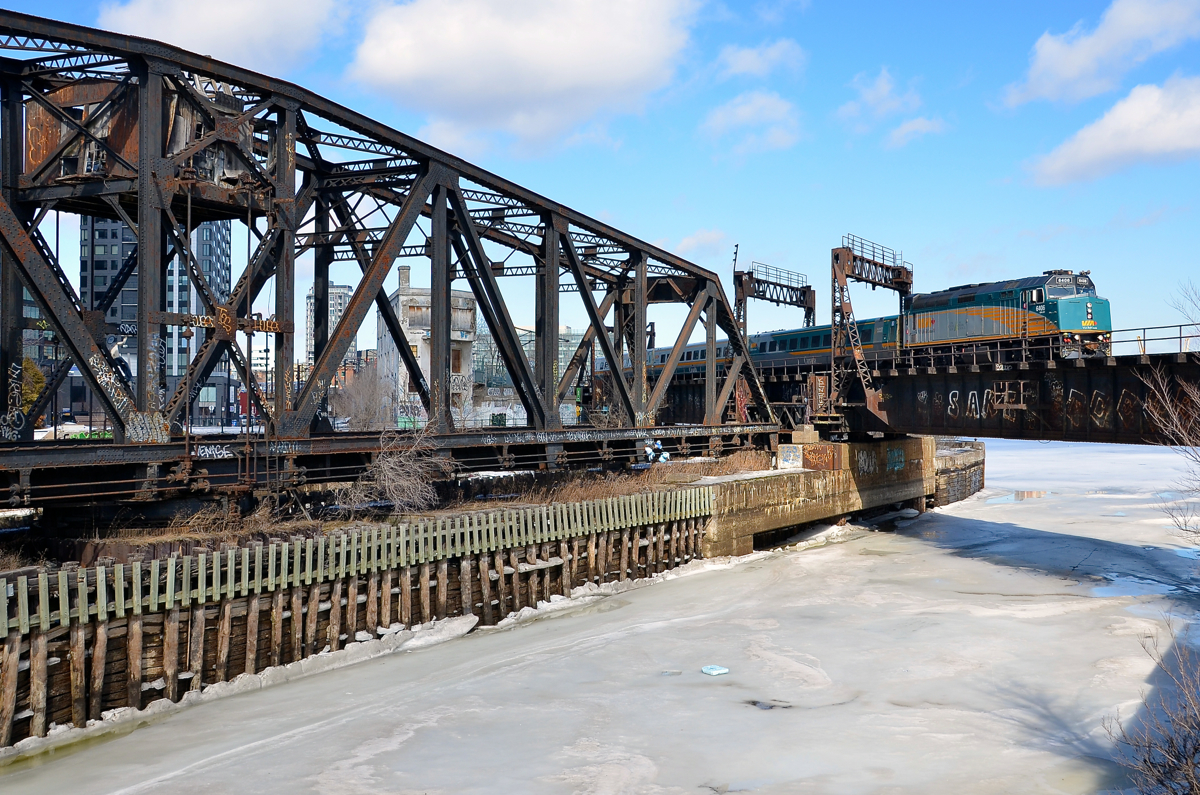 Over the frozen Lachine canal. VIA 55 for Toronto is passing Wellington tower and over the frozen Lachine canal.