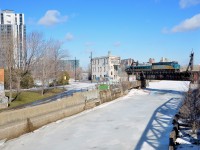 VIA 24 for Quebec City is passing Wellington tower and over the frozen Lachine canal.