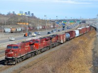 <b>CP power on CN 529.</b> CN 529 has three CP units for power (CP 8731, CP 8924 & CP 9700) on CN's Montreal sub. For the last month or so, CP power has been the most common power on this run-through train, which usually has NS power. In the background at left is the skyline of downtown Montreal.