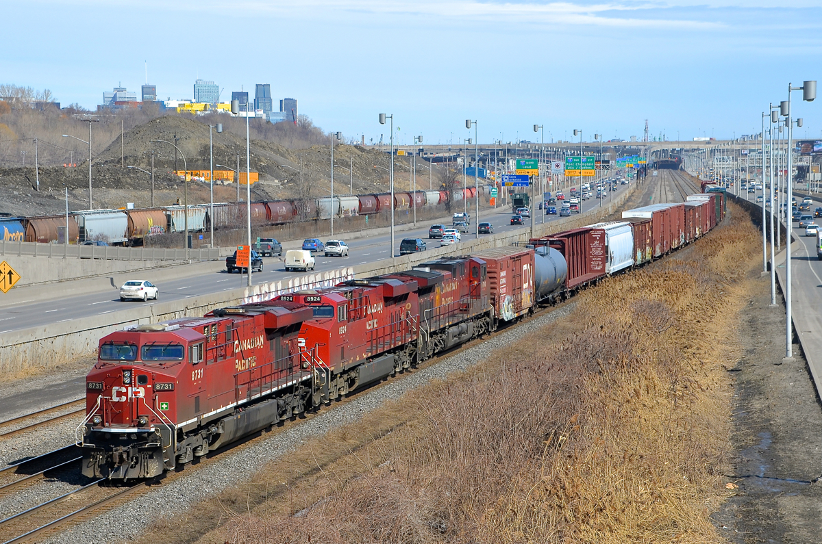 CP power on CN 529. CN 529 has three CP units for power (CP 8731, CP 8924 & CP 9700) on CN's Montreal sub. For the last month or so, CP power has been the most common power on this run-through train, which usually has NS power. In the background at left is the skyline of downtown Montreal.