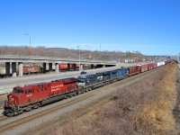 <b>Red, black and blue.</b> CN 529 has red, black and blue power and none of them are CN units (GE's CP 8930, NS 8140 & CEFX 1028) as it heads west on CN's Montreal sub on a gorgeous afternoon.