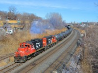 <b>Dual website GP9's.</b> A pair of clean GP9's, both in CN's current website paint scheme (CN 7246 & CN 7204) lead a transfer towards Taschereau Yard in Montreal on a sunny afternoon.