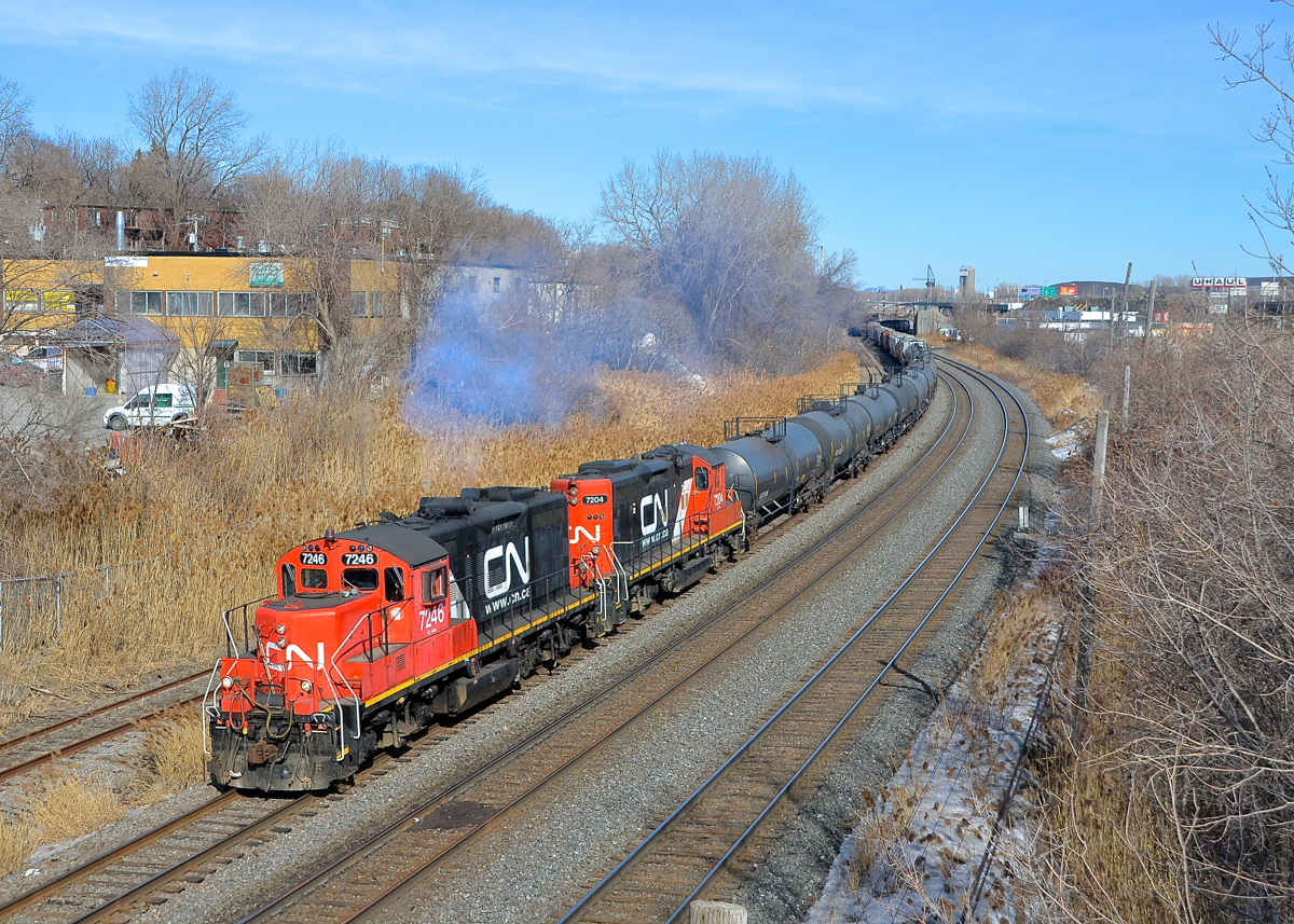 Dual website GP9's. A pair of clean GP9's, both in CN's current website paint scheme (CN 7246 & CN 7204) lead a transfer towards Taschereau Yard in Montreal on a sunny afternoon.