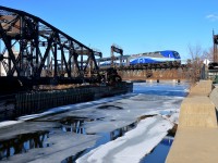 <b>Not much ice left.</b> There's not much ice left in the Lachine canal as AMT 1365 leads the 1650 departure for Mont-Saint-Hilaire (AMT 814) over it.