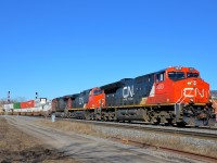<b>Newer to older GE's up front.</b> CN 120 is through the St-Henri neighbourhood of Montreal with a trio of GE's up front, organized newest to oldest. Leading is ET44AC CN 3033 (built in 2015), followed by Dash9-44CW CN 2626 (built in 2000) and CN 2137 (built in 1992 as ATSF 804). ES44AC CN 2809 (built in 2013) is also operating mid-train on this very long 636-axle intermodal train.