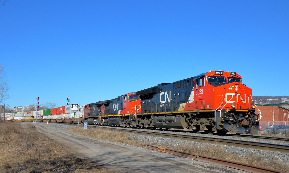 Newer to older GE's up front. CN 120 is through the St-Henri neighbourhood of Montreal with a trio of GE's up front, organized newest to oldest. Leading is ET44AC CN 3033 (built in 2015), followed by Dash9-44CW CN 2626 (built in 2000) and CN 2137 (built in 1992 as ATSF 804). ES44AC CN 2809 (built in 2013) is also operating mid-train on this very long 636-axle intermodal train.