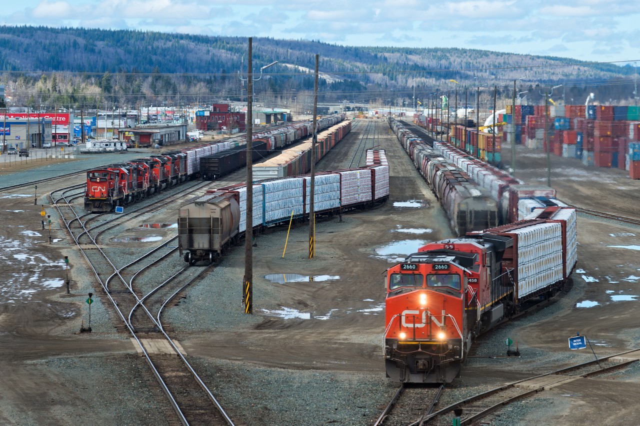 CN 348 with 2660 and IC 2458 is in the process of assembling its train in Prince George BC. The small yard pictured here is the "North Yard" which is situated along the east/west CN line. Most of the switching in Prince George is done at the much larger former BC Rail yard which is in a north/south orientation. Off to the side, waiting for 348 to triple its train together, is a yard job with a transfer movement bound for the former BCR yard. The power being; 1420,WC2002,7047,5473,8828,8807,5555.