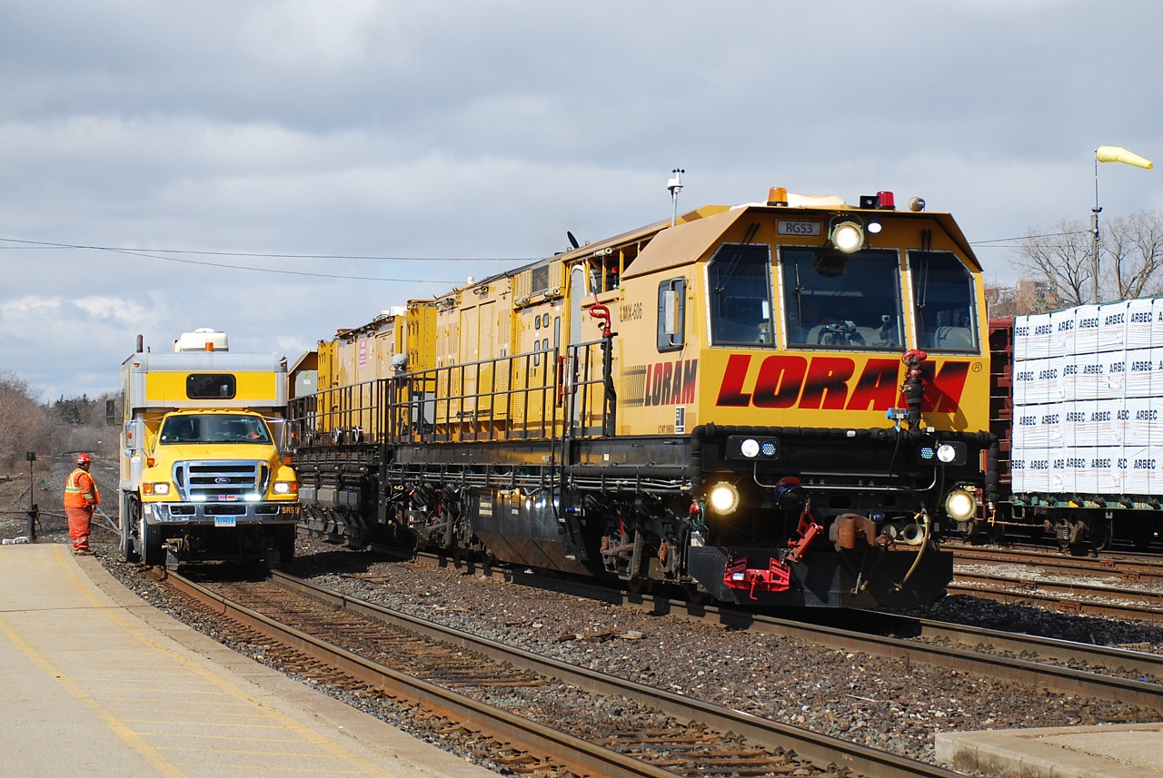 Hot times on the high iron this is not.  A Sperry truck is stopped on the south track adjacent to the CN office while a few employees take care of business inside.  Passing on the north track is a Loram rail grinder.  Not exactly what gets me excited, but having the two pieces of equipment side by side on the main was somewhat interesting.