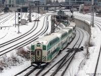 After completing its morning duties bringing Oshawa commuters into Hogtown, GO Transit equipment move #458 heads out to do her next run starting at Port Credit. GO cab car 220 leads the deadheading consist westbound with F59PH 524 providing the power on the rear, seen here exiting the flyunder at Bathurst Street past empty Bathurst North Yard at 7:58am during the AM rush hour. Train #452 inbound can be seen exiting the flyunder on the other side.<br><br>This L10 consist is assigned equipment set 19. What was a day in the life of set 19 like? It started its day at Willowbrook, deadheaded to Oshawa station as an equipment move, went into service Oshawa-Union as #427, went out of service at Union, and is seen here deadheading westbound as equipment move #458 to Port Credit GO station. At Port Credit it will enter service as #458 back to Union, and then deadhead back to Willowbrook around 9am. Its PM duties start around 2:00-2:30pm, when it will deadhead to Union for an equipment changeoff to take over the westbound trip of #919, then ping-pong back and forth on the Lakeshore corridor all evening until ending its day as #939 at Aldershot at 1:44xm (the next day), and deadheading back to Willowbrook (and then back in service again for the AM rush in a few hours, doing it all over again!).