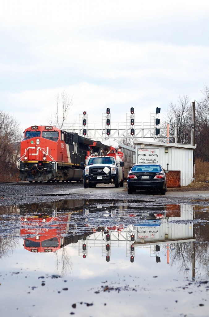 It is always hard to find water close enough to the tracks to get a nice reflection. This day found me in Georgetown briefly during a rain storm wait a green signal. luckily the rain stopped long enough for me to take this shot, while not totally what I wanted the result left me somewhat satisfied, and catching consecutive GEVO T4's wasn't bad either.