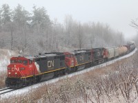 A CN eastbound makes its way through the freezing rain covered landscape north of Milton. The lead Dash-8 has been repainted and is now equipped with DPU. 