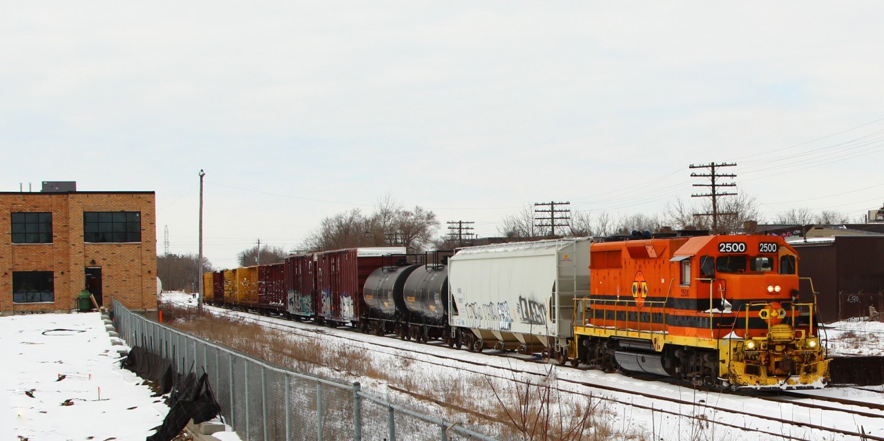 Gatineau Quebec 2500 has been servicing the industries along the Goderich Exeter main line at MM49.5 on the Guelph Sub and is about to cross Edinburgh Rd in Guelph.
