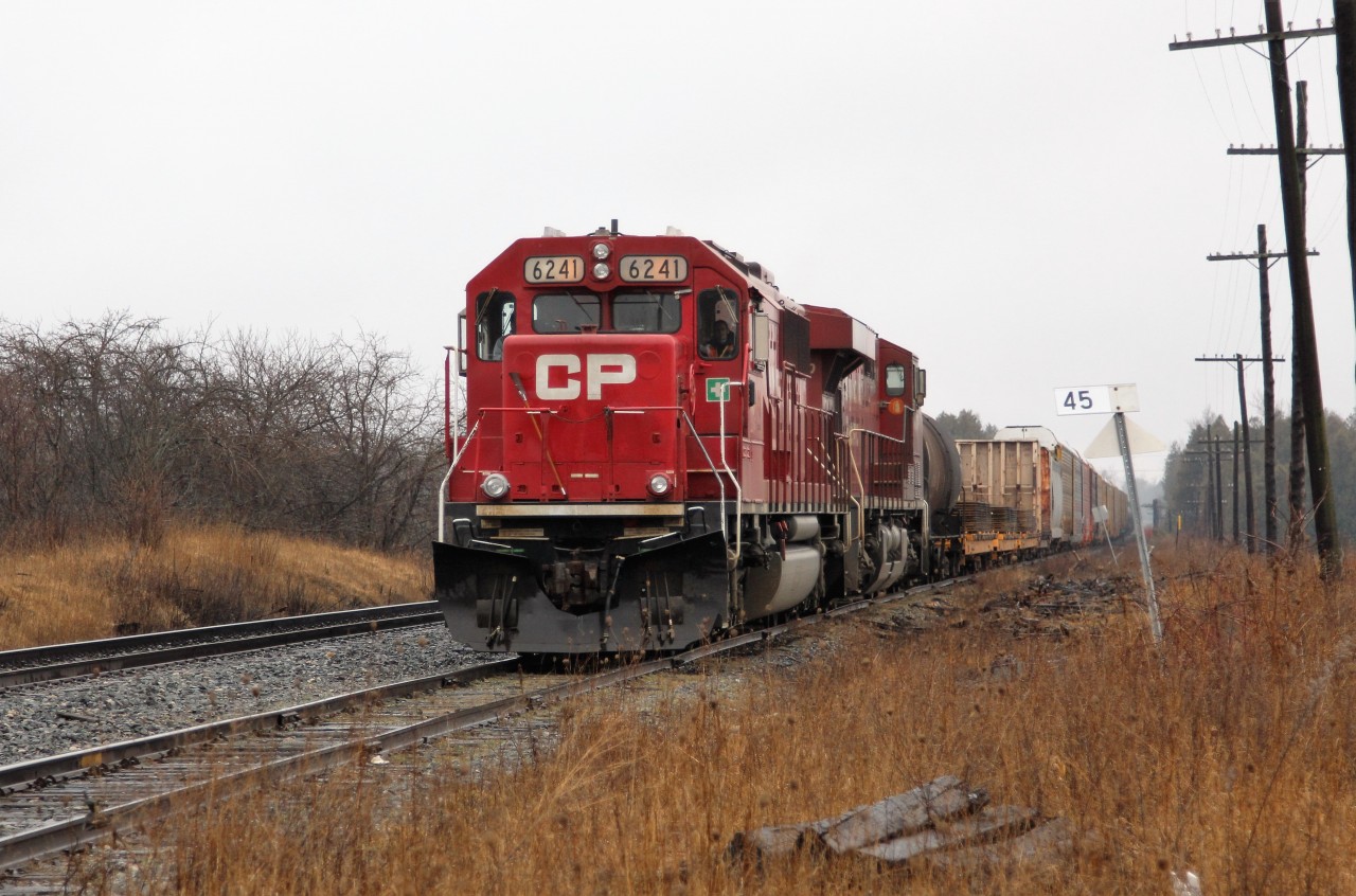 On a damp, drizzly afternoon, Ex-SOO, CP 6241 (GMD SD60) with CP 8720 ease their way up the Puslinch siding at MM45 on the Galt sub to wait for a north bound train to clear the Hamilton sub before they can proceed east then south down to Hamilton.