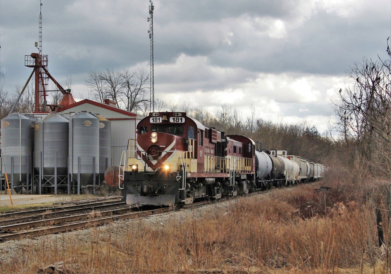 After doing its daily switch in Guelph Junction, Guelph Junction Railway 181 (MLW RS18u) along with GJR 505 (MLW RS23) make their way back to Guelph and through the village of Moffat and past Sharpe Farm Supply.