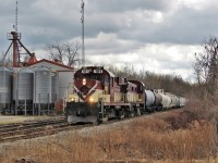  After doing its daily switch in Guelph Junction, Guelph Junction Railway 181 (MLW RS18u) along with GJR 505 (MLW RS23) make their way back to Guelph and through the village of Moffat and past Sharpe Farm Supply. 