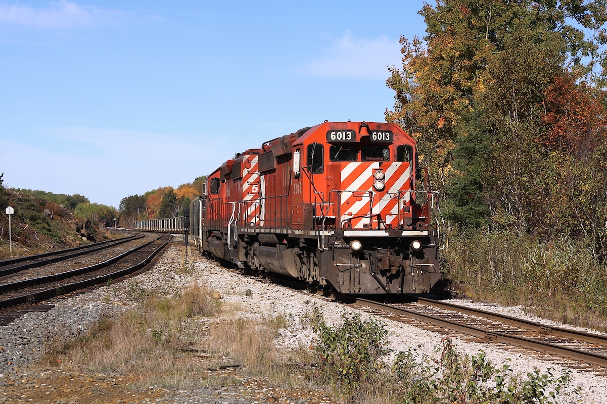 The Levack Turn is in the process of leaving CP's Cartier Sub and heading down the Levack Spur towards Coleman Mine. There it will exchange its empty string of gondolas for cars loaded with nickel ore. Then the train will proceed back to the concentrator at Clarabelle Mill in Sudbury.