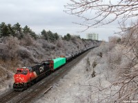 Moncton - Toronto manifest M305 throttles down approaching its destination of Toronto's MacMillan Yard passing under Hilda Ave in Thornhill, Ontario. With over 500 axles of freight, another ES44 would be seen pushing mid train. M305 had met its counterpart M306 at CN McCowans. 