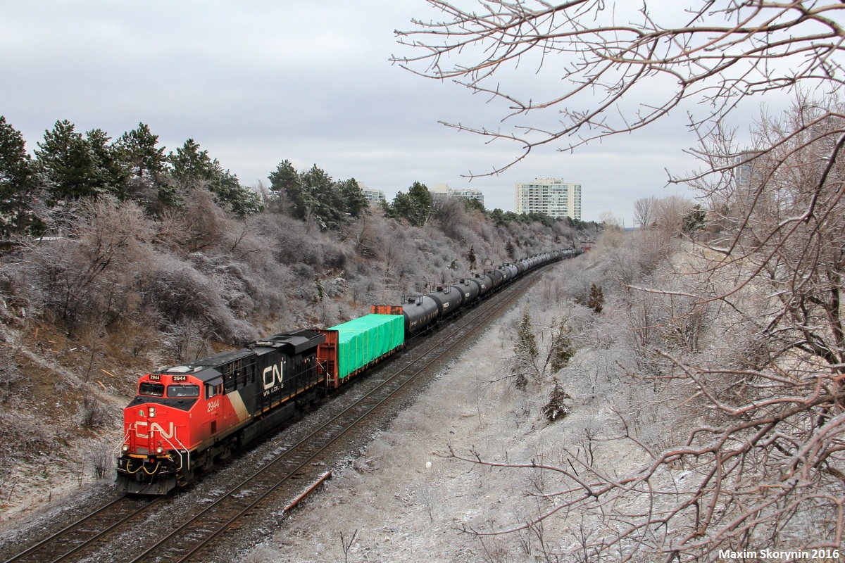 Moncton - Toronto manifest M305 throttles down approaching its destination of Toronto's MacMillan Yard passing under Hilda Ave in Thornhill, Ontario. With over 500 axles of freight, another ES44 would be seen pushing mid train. M305 had met its counterpart M306 at CN McCowans.