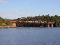 A couple of matching engines lead a northbound CP freight over the French River. This 415 foot truss bridge was built in 1907 and set in place by a process known as incremental launching. Due to the deep water at the construction site, the entire structure was assembled on the north shore of the river and then launched across the span using a 32 horsepower Beatty hoisting engine.