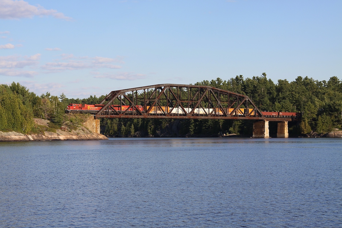 A couple of matching engines lead a northbound CP freight over the French River. This 415 foot truss bridge was built in 1907 and set in place by a process known as incremental launching. Due to the deep water at the construction site, the entire structure was assembled on the north shore of the river and then launched across the span using a 32 horsepower Beatty hoisting engine.