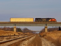 I had wanted to get a shot here for a while. A CN on the Stamford Sub passing over the CP Hamilton Sub. Knowing CN 531 typically departs at 1600 from Port Robinson, I went to go see it there. As it left I took off towards Welland. However, I clearly forgot to factor in the many granny drivers in Niagara, so things didn't go as planned. I ended up being a dead head to head chase with 531, and then finally got ahead. However, when I rushed down to the CP ROW, I was welcomed with dead silence for several minutes. Southern Yard is just north of here, and it was clear to me he was working the yard, much to my relief. Nonetheless, I was a bit perplexed to see it cross with a single loaded centerbeam. I could guess where this single centerbeam was going, but I won't. I decided to chase after it, which was a mistake, as CP 255 was coming. I was not aware of this until I saw CN 531 meeting it at Robbins, and at that point it was too late, as I was hit by constant red lights on the way back. Sometimes luck gets countered by a lack of it.
<br>
<br>
The signal bridge in the distance is the former Brookfield controlled interlocking, where the CP Hamilton Sub once went to Niagara Falls. All there is now is an advance signal for CP to merge onto the CN Stamford Sub at Robbins, and a connecting track onto the former Hamilton Sub to Niagara Falls, which is now the Montrose Sub.