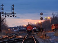 Port Robinson... Not a location I particularly like, but find myself here all too often as this is where the trains are in Niagara, even if they may not be moving. CN 5703, one of the small noodle SD75I's, sits on what would be classified as the mainline bypass track about eight years ago. Things have changed though, and much of the traffic that used to pass through here is gone. This is currently CN's only interchange yard in Niagara. Southern Yard in Welland and Fort Erie yard act as temporary storage yards, and for transfers. Having the brunt of Niagara's traffic shoved into one yard clearly doesn't seem to mean much, as the yard is rarely full. However, CN 330 is at the opposite end of the yard, and 530 has yet to return with traffic from Buffalo. Once everything is settled around 11pm, the yard should be relatively full momentarily before 330's traffic leaves as 539 for Buffalo. Since the yard has no through traffic anymore besides the odd CN 232, CN often doesn't bother using the engine track where CN 2033 sits.