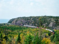 Just a hair to the west of the hamlet of Neys, and the Provincial Park of the same name, is this great photo location. Best in the morning as the sun climbs enough to eliminate foreground shadows, images like this can be had. Lake Superior is off to the left, and the SD90MACS CP 9135 and 9122 are rounding the bend eastbound over the Little Pic River bridge. I was hoping for a few nice angles here, but as luck (or lack of) would have it, on the way back from Thunder Bay we found CP experienced a derailment at Coldwell. So here I am, up around Superior, and all the trains have ground to a halt. Thems the breaks. :o(
For those interested, this image was captured on 400 ISO 120 film set at f5.6 and 500th sec using a Mamiya 645E.