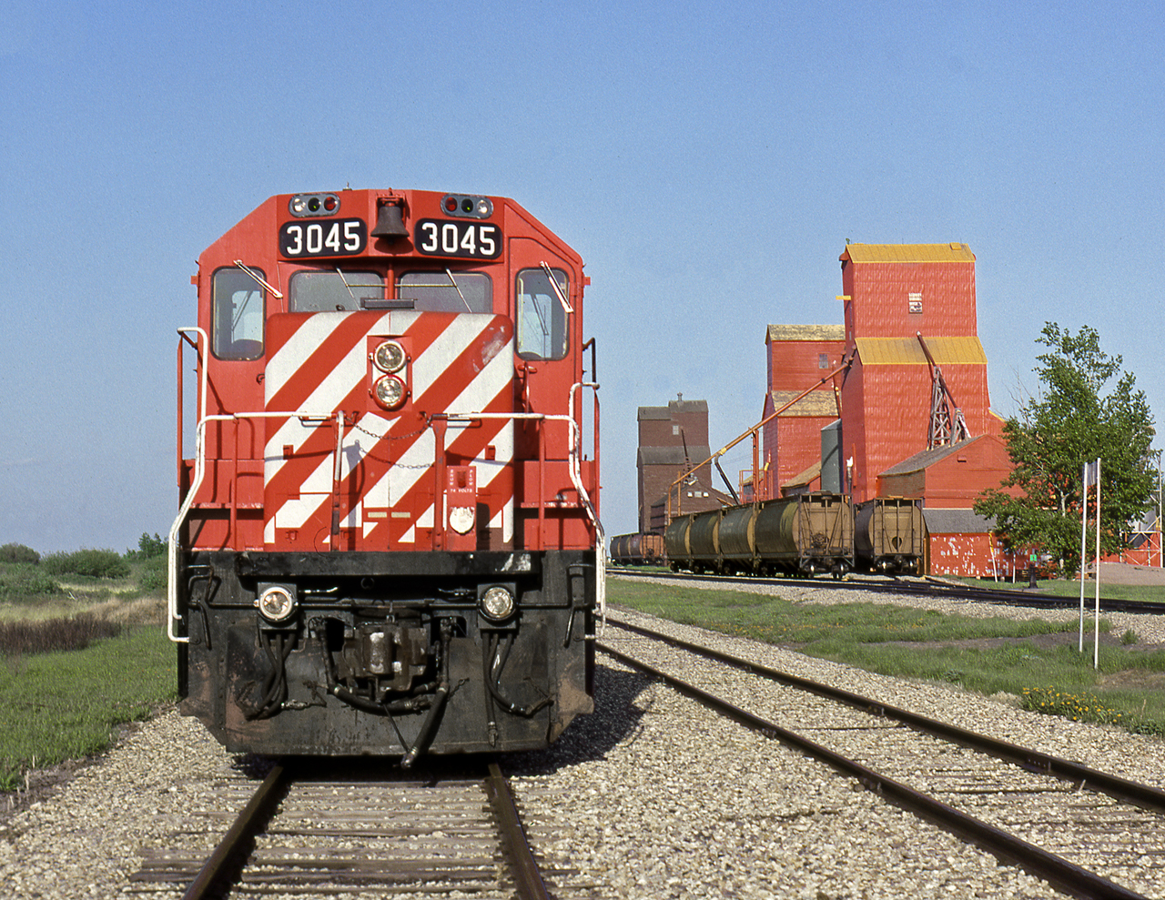 Light engines having returned from spotting grain empties to Esterhazy, sit on the back track at Neudorf the terminal between the Brandon and Regina Divisions. In the morning the power will head west picking up loads on the Bulyea Subdivison.