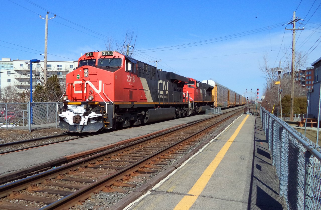 the CN-2318 a EF_644m with CN-8017 a SD-70m2 pulling a convoy of freights car coming from a stop at Joffre yard near Québec city  and dropping cars in Southwark yard Longueuil was on cn route 401 next stop Tachereau yard near Dorval MTL