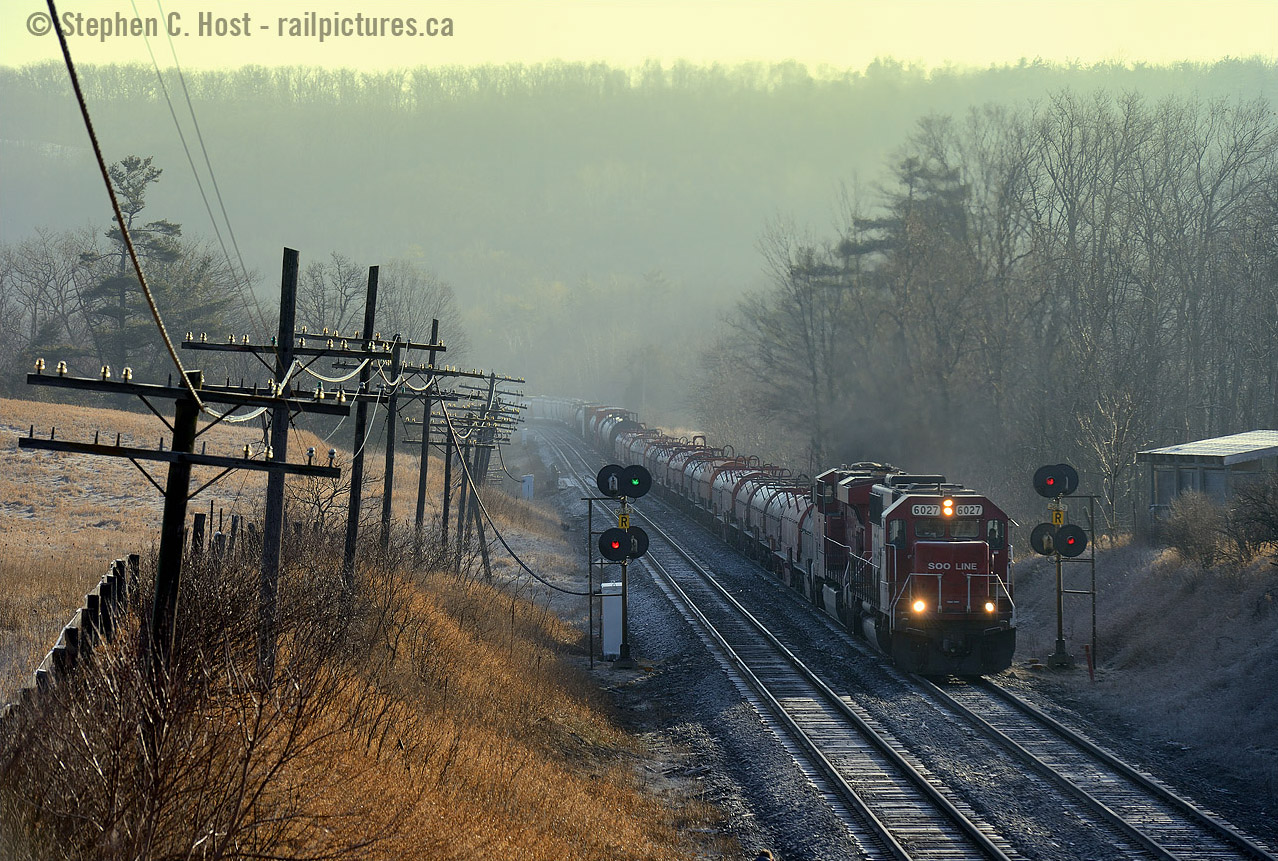 Appearing out of the fog, glowing yellow with the rays of a morning sun, CP 246 roars upgrade toward Guelph Junction. While the engines may get a bit of a reprieve once they reach the Hamilton sub, the use of dynamics for the Waterdown hill and one more upgrade assault of the escarpment through Stoney Creek to Vinemount are yet to come. Not a problem for this DC-AC combo, a favourite of the CP power planning department, SD60's are a regular thing on trains to and from Buffalo and a nice break from the usual GE monotony.