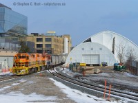 <b>The great domes</b> now dominate the Kitchener landscape as construction of the "ION" LRT infrastructure continues - this will be used to pour concrete this week for the King St underpass, and to keep the project on-time a $2M Dome was required to cover the site. This work should have been done earlier this year but Metrolinx purchase of the track plus other things delayed the underpass project adding to the local taxpayer ire (as reported in the papers). ION is expected to be in service in 2017.<br><br>
At left of the dome is a new glass and yellow brick industrial building retrofit - for the new Google Canadian headquarters - you can kind of see the familiar Google logo colours on the white silo. The track at right is the Huron Park Spur which has been re-aligned. 





