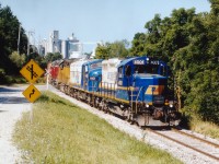 Working the stiff grade up from Lake Huron and the Sifto Salt company, GEXR hauls loads of salt in limited numbers and puts the train together up at the yard. Four units are seen 'sweating it out' crossing North Harbour Rd. Nice variety of power, the leader 4001 RaiLink paint; still sports 'Lakeland & Waterways" on the flank, another RLK outfit in Alberta (Central Alberta Rwy) at the time....this unit was shipped east to the GEXR via CN in late September 2002. Other units are RA 1401 (now on OSR) and LLPX 2236, GEXR 3821. The train will run to Stratford.
