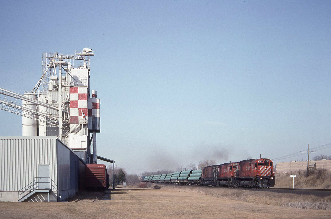Train 508 CP 4707 4570 4572 passing the Whitby station sign just to the west of the Hopkins street crossing. To the left the old Purina feel mill. The building today for the most part is gone and houses a recycling facility with no rail access and a fence blocking any kind of a decent shot.