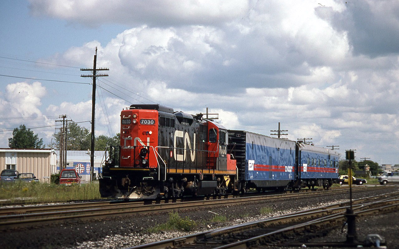 CN track geometry train 7030 15007 and 15008 sits just west of the Egerton street crossing in London holding the north main. Crew changes still took place in London with the yard office to the left of 7030.
