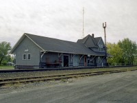 Another one of those old CN stations, size alone killing its modern day usefulness; as times change and trains need not stop here any more. Everything at this station shows it's purpose: baggage cart (good size one, too!)  for the mail and parcels, two freight doors; passenger waiting area and bench out front, main office for agent and his living quarters on the upper floor; these structures were once all-beneficial to the world outside the village boundaries. Today, this building, like most, is long gone.