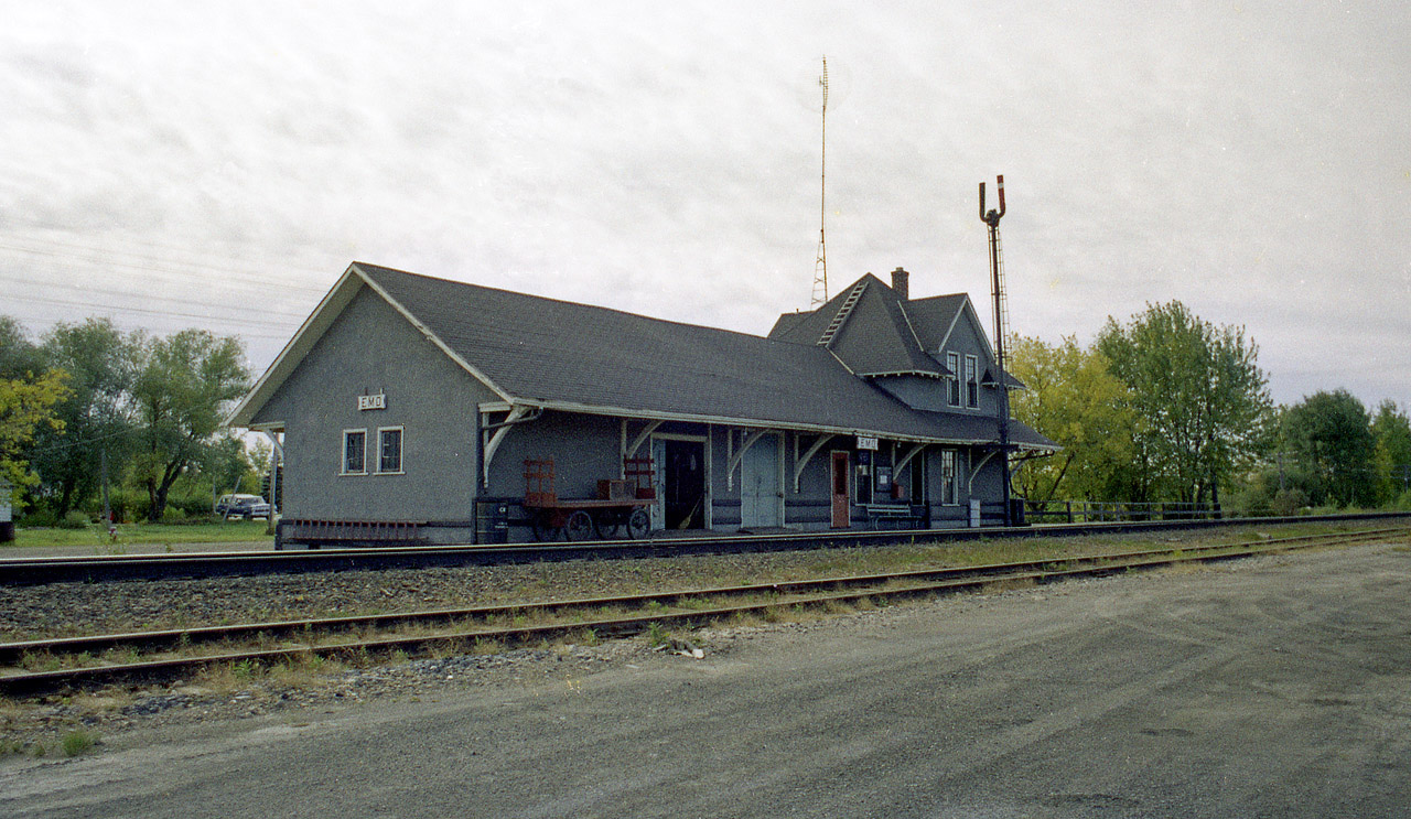Another one of those old CN stations, size alone killing its modern day usefulness; as times change and trains need not stop here any more. Everything at this station shows it's purpose: baggage cart (good size one, too!)  for the mail and parcels, two freight doors; passenger waiting area and bench out front, main office for agent and his living quarters on the upper floor; these structures were once all-beneficial to the world outside the village boundaries. Today, this building, like most, is long gone.