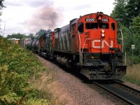 An eastbound manifest train with two M636's leading chugs through Windsor Junction. On my previous visits to Halifax, it seemed as though all the freight trains operated at night. My '86 though, operations changed  and a few freight trains could be seen. Without a radio, however, it was really tough to catch one.