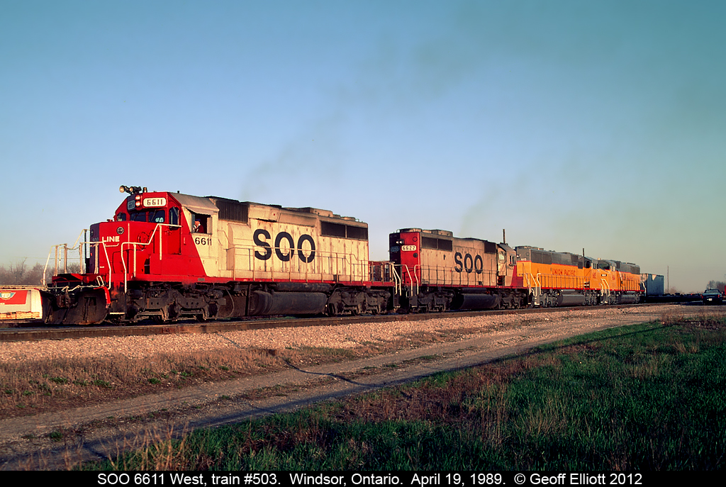 All about 'pairs'.... A pair of SOO SD40-2's, 6611 and 6622, lead a brand new pair of Union Pacific SD60M's past Windsor South depot in Windsor, Ontario in late afternoon sun back on April 19, 1989.