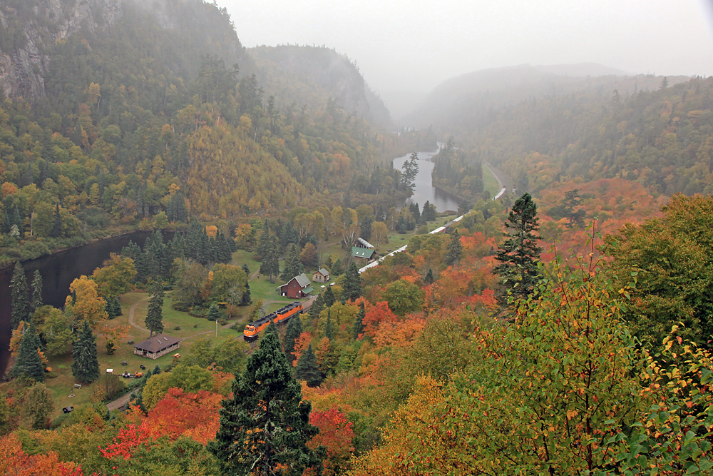 One of the iconic shots of the Agawa Canyon Tour Train has always been the shot looking down on the park from the Lookout. Only problem (for the day-trippers anyway) was by the time you scampered up the 372 steps to get there they'd already uncoupled the power from the front end of the train and run it around to the back end in preparation for the return trip. We solved this problem by booking the Canyon View "Camp Car" for the last week of operations several years running (until the price encroaching the $2K zone combined with the horrifically lumpy mattresses and the constant septic system backups made it no longer overly attractive to us). We'd climb up there almost every day to wait for the train and after it arrived, fight the onslaught of stair-climbers to get back down to the bottom. There are always those tour passengers who were so in awe of their own athletic prowess that they'd take great glee in running to the top ahead of everyone else, so we'd time it just right that we'd meet them about 20 steps down just to see the looks on their faces when confronted with a couple of (upper) middle-aged folk loaded with a ton of camera gear coming back down and telling them "only a few steps more and you're in for a beautiful view"! After we'd got back down and had lunch, and all the tour passengers had been herded back on board we'd shoot the train as it was departing, another opportunity not available to those who didn't actually stay there.