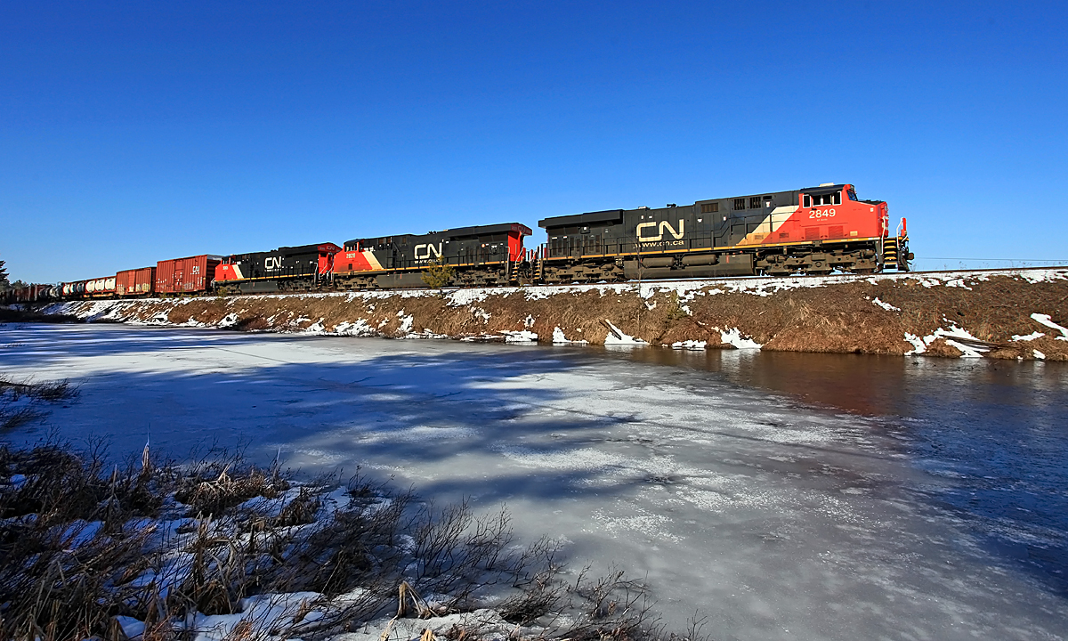 A normally nocturnal CN 451 - running late enough to put it well into daylight - approaches the south switch at Martins on its way from MacMillan Yard in Vaughan to North Bay.