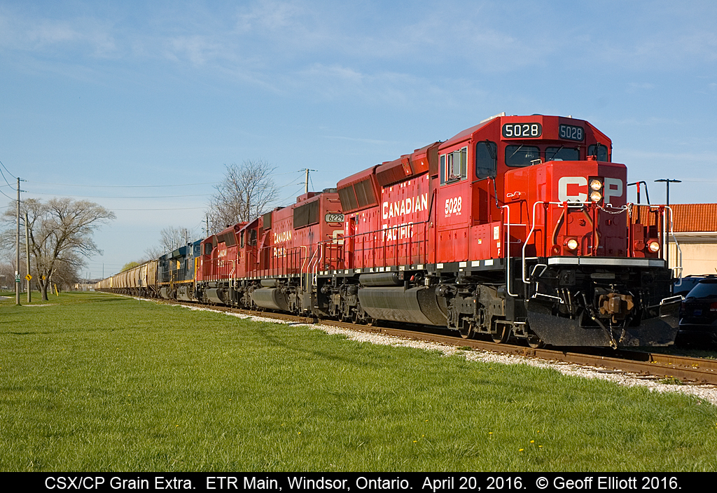 Big move on the Essex Terminal today as another CSX unit grain train is delivered to the ETR for forwarding to ADM out in Ojibway. Train arrived early this morning with CSX 3292 and 772 as power. Train was tied down @ Dougal Ave. until T28's power, CP 5028, 6229, and 5024 were added to the head end. From there T28 pulled the 80 car empty train east onto the ETR and down past Howard Ave to clear the crossovers at Lakeshore. ETR GP9 #108 would have the honors of taking the train to ADM and it waited for 5024 to shove back to where it was waiting. Once ETR 108 was coupled on and had air on the train, T28/CSX power was cut away and ETR 108 headed for Ojibway while the CP/CSX consist headed back to Windsor Yard. - See more at: http://www.railpictures.ca/?attachment_id=24346#sthash.Y4BrIMvW.dpuf