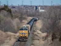 A single UP GEVO leads a snake of empty ethanol tanks up the hill through Newtonville.

UP 5549