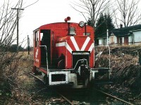 [Editors note: understanding the quality of this is a bit shaky, but letting it in for historical interest] I really have to jog my memory about this site! I do know that it was early in 1981 when I took the time to walk around the site. CF 107 was sitting outside on the west side of the larger shop building. It had clearly been there for quite some time as the encroaching blackberry growth was moving closer. The day was overcast and damp, which was typical for that time of year. I took 3 pictures of the locomotive. I often wonder what type of support was under the hood to carry the weight of that bell?