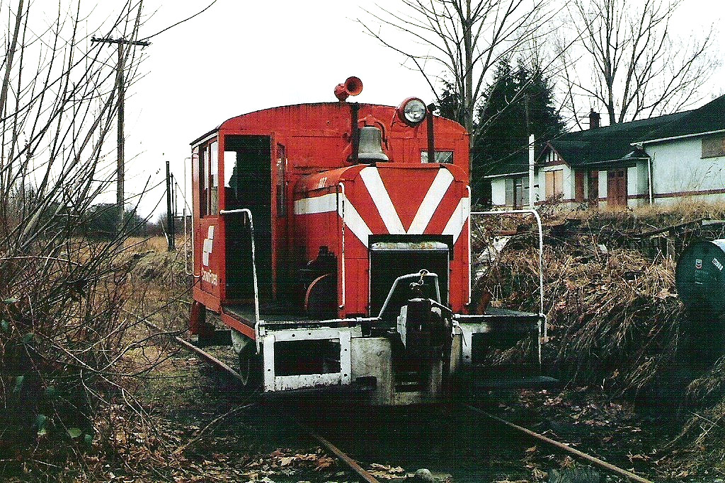 I really have to jog my memory about this site! I do know that it was early in 1981 when I took the time to walk around the site. CF 107 was sitting outside on the west side of the larger shop building. It had clearly been there for quite some time as the encroaching blackberry growth was moving closer. The day was overcast and damp, which was typical for that time of year. I took 3 pictures of the locomotive. I often wonder what type of support was under the hood to carry the weight of that bell?