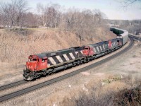 A day at Bayview as it used to be: No fences, no hassles, and this particular day, no fans, either. Except this one. And the reward was this westbound with a pair of M-636s up front, CN 2307 and 2305, both off the roster for 20 years now. Trailing is a puny SD-40 # 5080, and since they are all off the CN roster as well, I guess we can tolerate it. I went ahead of this train as far as Copetown. To hear them struggle on the grade was a real treat.